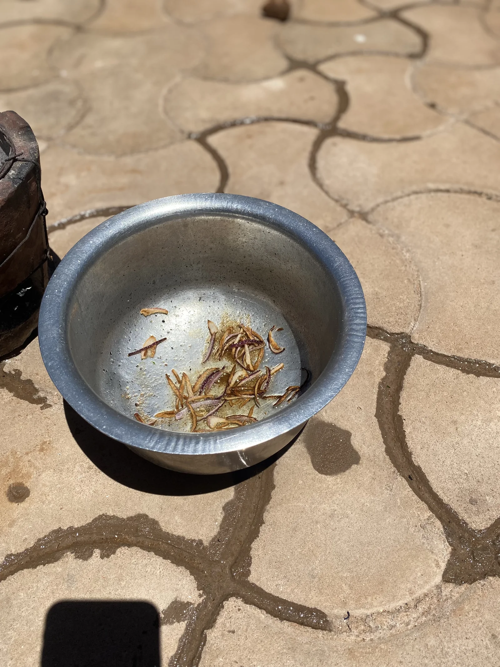 Cooking oil being used to prepare onions in a saucepan
